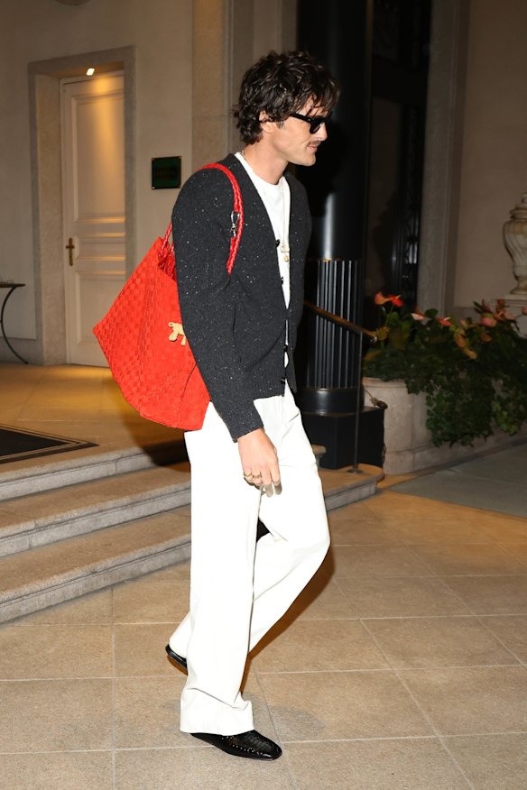 Jacob Elordi at Milan Fashion Week in September 2024 carrying a custom Bottega Veneta bag. Elordi is slowly acquiring a formidable handbag collection.