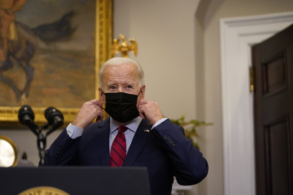 President Joe Biden removes his mask before speaking to the media on Saturday.