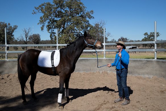 Scott Brodie with a retired racing horse used in an equine therapy program run by Racing NSW at St Heliers Correctional Centre in Muswellbrook, NSW.