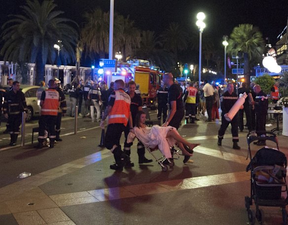 Wounded people are evacuated from the scene where a truck crashed into the crowd during the Bastille Day celebrations in Nice, France.