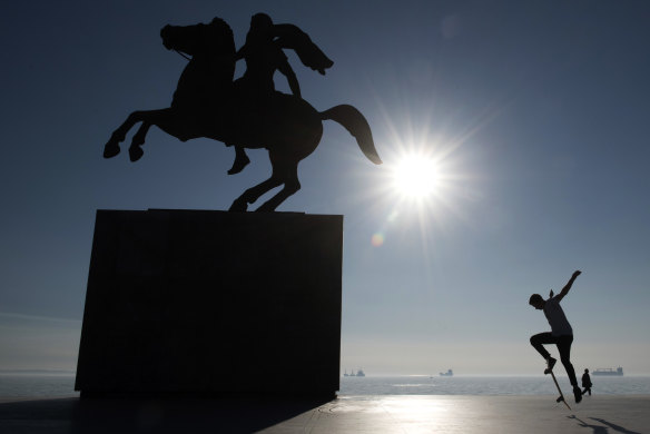 A skateboarder practises next to a bronze statue of Alexander the Great on his famous horse Bucephalus in the northern port city of Thessaloniki , Greece.
