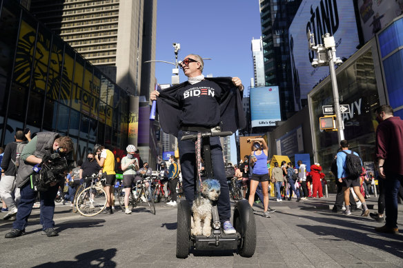 People celebrate in Times Square after former vice-president and Democratic presidential candidate Joe Biden was announced as the winner.