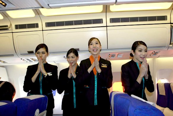 Thai transsexual flight attendants, from left to right, Phuntakarn Sringern, Nathatai Sukkaset, Chayathisa Nakmai and Dissanai Chitpraphachin, greet passengers.