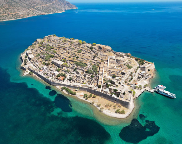 The remains of a Venetian fortress and Ottoman-era houses against a blue sea are bizarrely picturesque in Spinalonga.