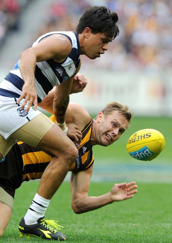 Geelong's Allen Christensen and Sam Mitchell have eyes for the ball.