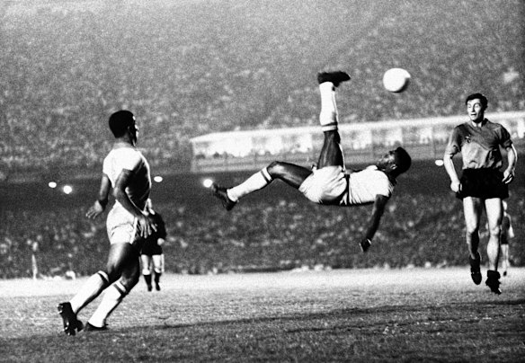 Pele kicks the ball over his head during a game in 1968.