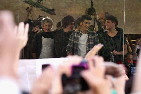 Shock ... One Direction look out to fans during their visit to Sunrise Martin Place studio.