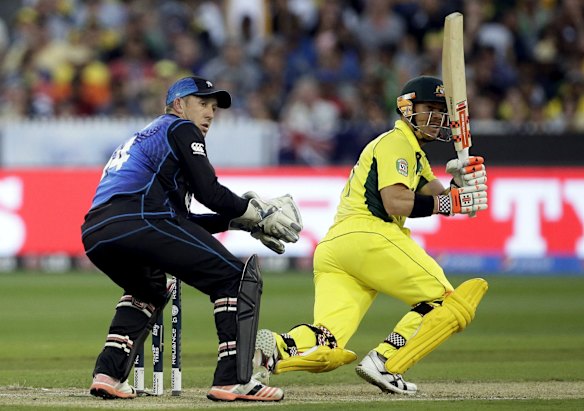 David Warner flicks a ball to the boundary as Luke Ronchi looks on.