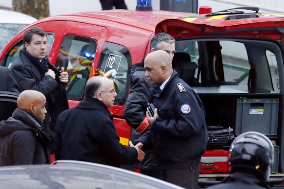 Police, paramedics and firefighters at the scene of the shooting in the south Paris on Thursday, January 8. 