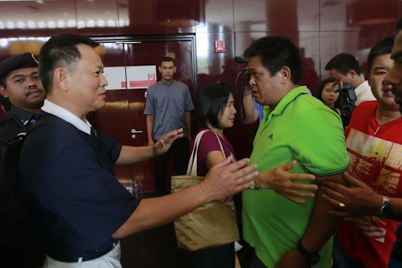 An upset relative of a passenger of the missing Malaysia Airlines flight MH370 approaches an official at a hotel in Putrajaya.