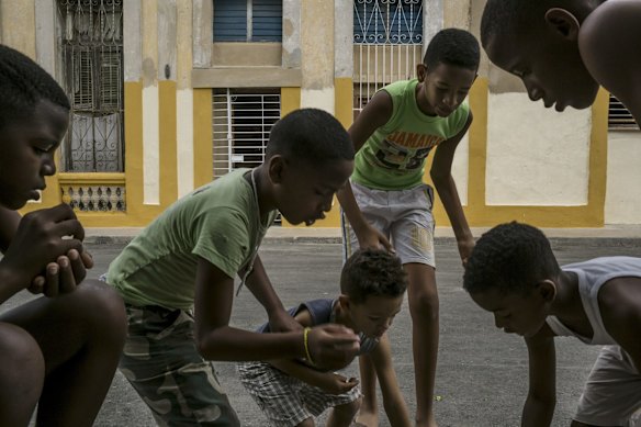 Boys play marbles near the Latinoamericano stadium in Havana, where President Barack Obama will watch Cuba's national baseball team play Major League Baseball's Tampa Bay Rays on Tuesday.