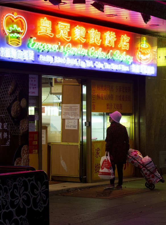 A lone shopper checks the menu without stepping inside.