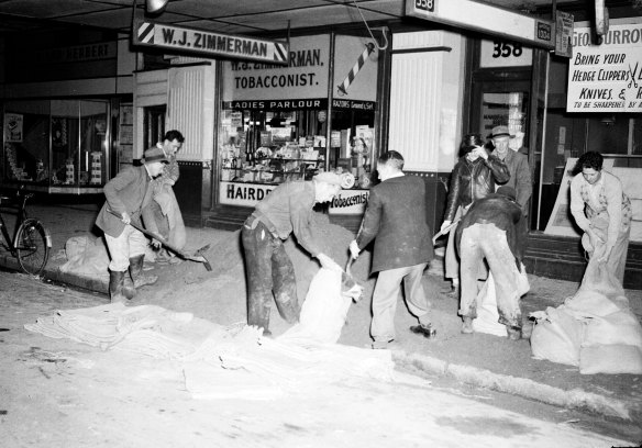 “Men filling sandbags yesterday to strengthen the river bank at Maitland before the river reached a peak of 36 feet nine inches.” August 8, 1952.