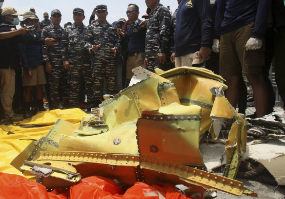 Navy personnel gather around debris recovered from the sea where the Lion Air jet is believed to have crashed in the waters of Tanjung Karawang, Indonesia, on Thursday.