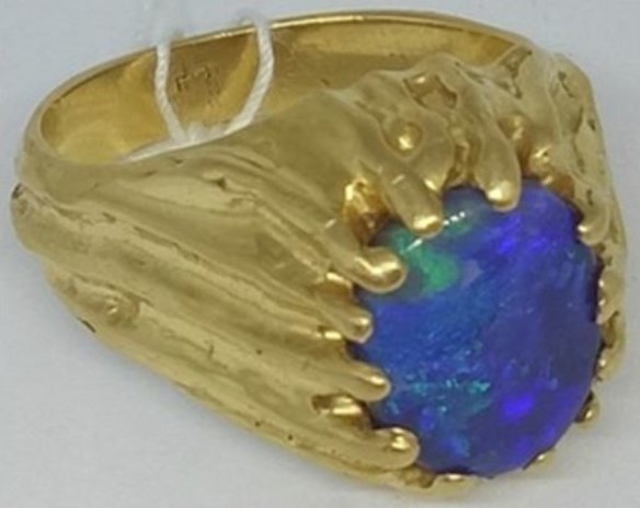 The 18-carat gold ring with an opal stone.