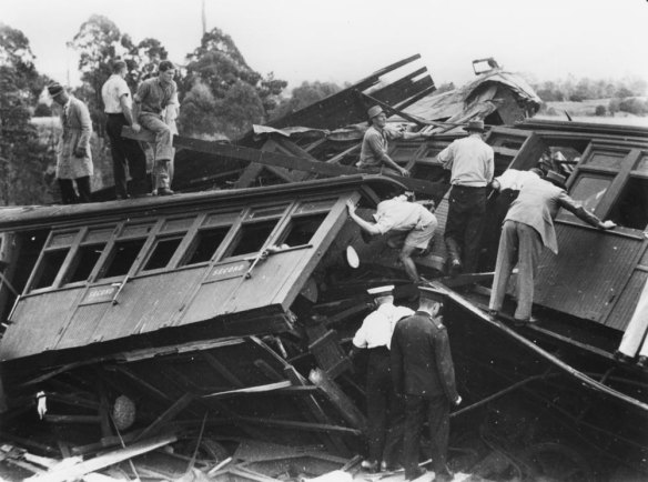 Rescuers inspect the wreckage of the Camp Mountain train disaster. 