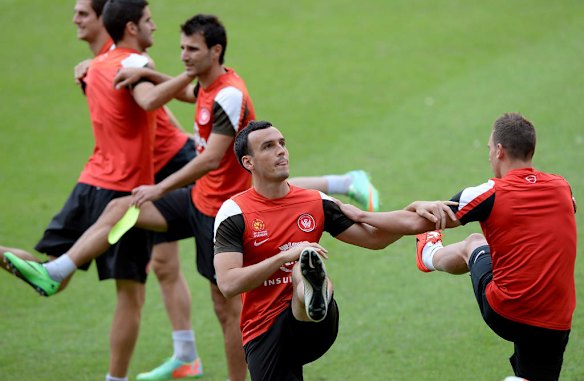 Mark Bridge and team mates warm up during a Western Sydney Wanderers A-League training session at Suncorp Stadium.