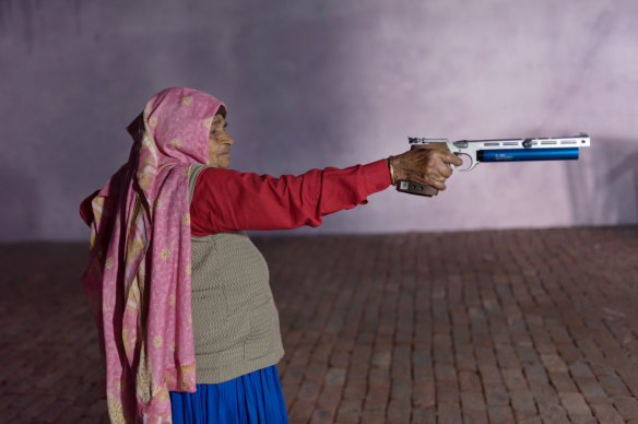 Chandro Tomar, 89, practices with her air pistol at a range being built at her house in the village of Johri, India, Feb. 14, 2021.