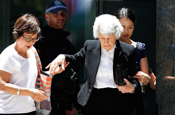 People evacuate a building next to the siege at Lindt Cafe in Martin Place.