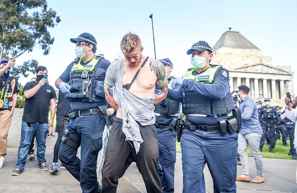 Police making an arrest after a scuffle with protestors.