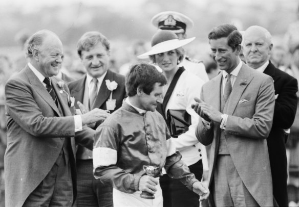 Prince Charles congratulates the winning jockey, Pat Hyland at the 1985 Melbourne Cup presentation ceremony. 
From left to right, Hilton Nicholas, chairman of the VRC; John Elliott, chairman of Carlton United Breweries;
Princess Diana; Peter Armytage, senior vice-president of the VRC (behind Prince Charles). 