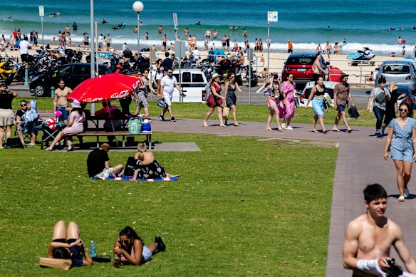 People enjoying the long weekend at Bondi Beach, the carpark busy but not closed.