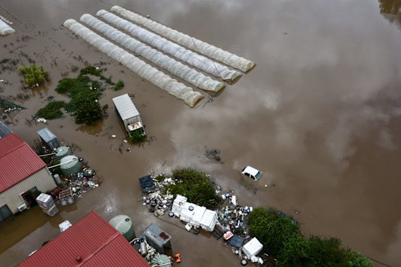 Flooding surrounds greenhouses along the Nepean river near Greendale.