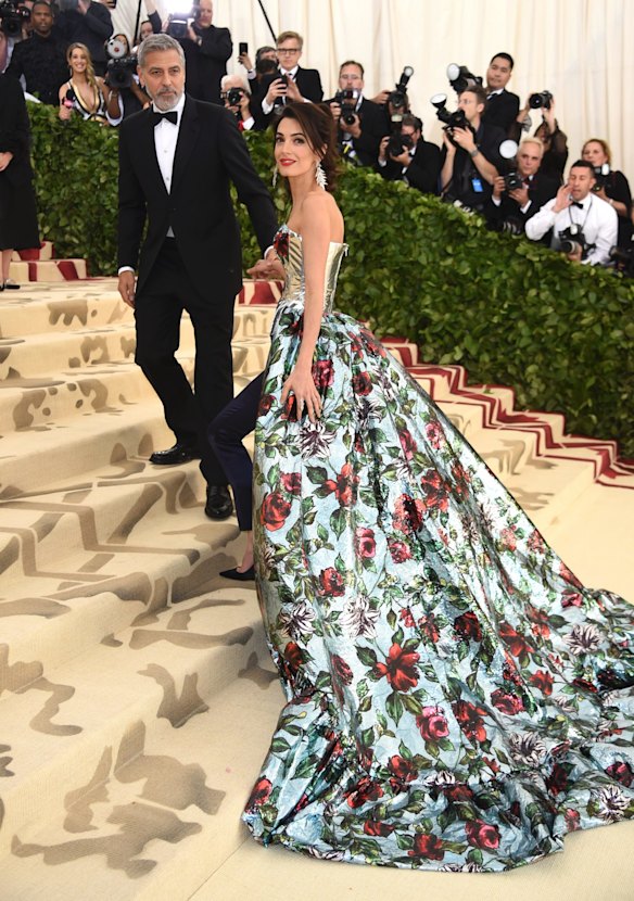 George Clooney, left, and Amal Clooney attend The Metropolitan Museum of Art's Costume Institute benefit gala celebrating the opening of the Heavenly Bodies: Fashion and the Catholic Imagination exhibition on Monday, May 7, 2018, in New York.