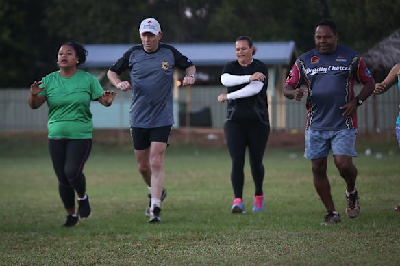 Tony Abbott works out with members of the Bamaga community during his visit to Cape York.