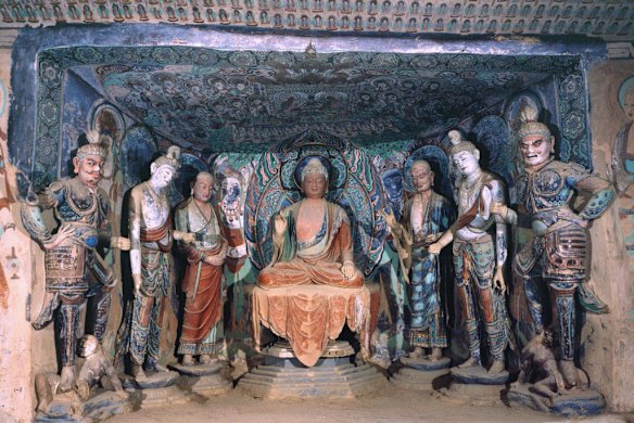 Buddha and disciples in the Mogao Caves, one of 500 painted caves remaining. Photo: Dunhuang Academy.