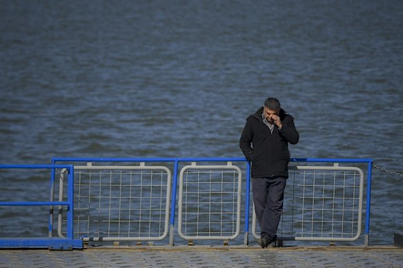 A man waits to cross the Isaccea-Orlivka border crossing in Romania by ferry.