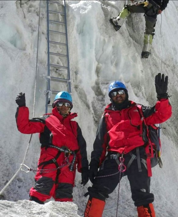 Dinesh and Tarakeshwari Rathod in their red gear on Everest.