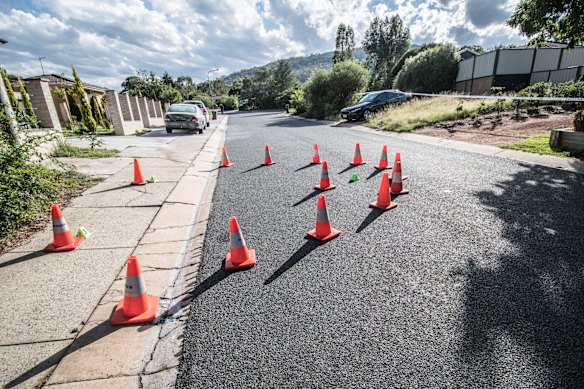 Police officers and forensic staff attend the scene of an overnight shooting and arson attack in Harrington circuit, Kambah. Numerous bullets have hit the home and three vehicles have been set alight. 