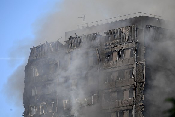 Smoke rises after a huge fire engulfed the 24 story Grenfell Tower in Latimer Road, West London in the early hours of this morning on June 14, 2017 in London, England.