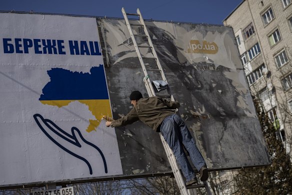 A worker sets up a billboard with the colours of the Ukrainian flag in Novoiavorisk, near Lviv, western Ukraine. Local company Propet Print has been installing patriotic-themed billboards in Lviv since the start of the war.