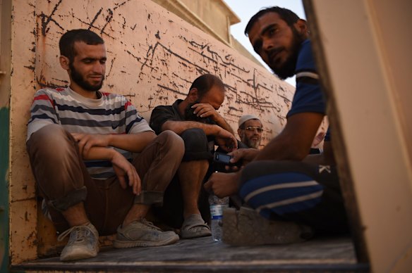 A man weeps in the back of a truck at a screening point in West Mosul after fleeing Islamic State. 