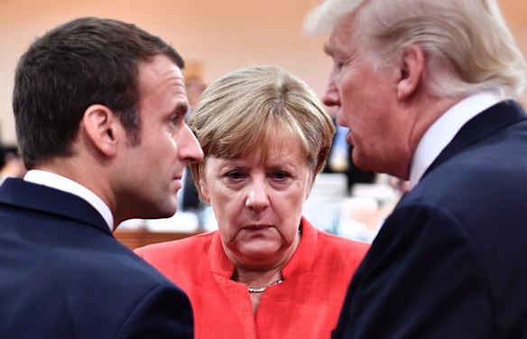 French President Emmanuel Macron, German Chancellor Angela Merkel and US President Donald Trump are engaged in conversation at the start of the first working session of the G-20 meeting in Hamburg, northern Germany.