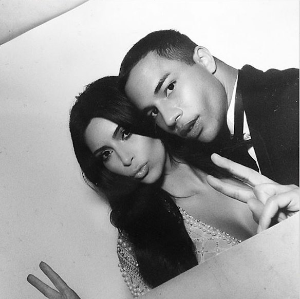 Kim wearing wedding dress number two with designer Oliver Rousteing.