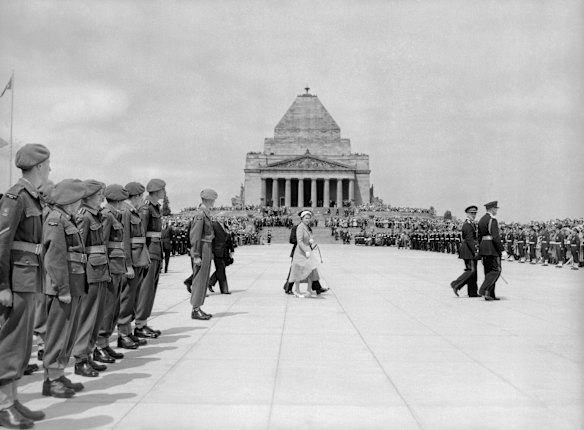 After dedicating the forecourt at the Shrine of Remembrance in Melbourne, Victoria, The Queen walks across it to inspect the eternal flame. 28th February, 1954.