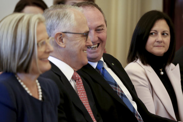 July 19, 2016: Lucy Turnbull and Natalie Joyce look on as Malcolm Turnbull and Barnaby Joyce share a laugh during the swearing-in ceremony at Government House