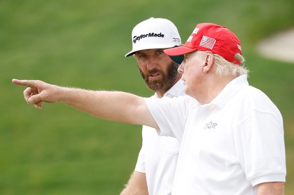 President Donald Trump talks to Dustin Johnson of the 4 Aces GC during the pro-am ahead of the LIV Golf Invitational at Trump National Golf Club Bedminster.