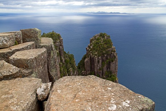 BISHOP & CLERK: Rising tall from the northern edge of Maria Island are the 599-metre-high rock towers known as Bishop and Clerk. From the island ferry terminal, a trail wanders through the former convict settlement of Darlington and out to the top of the Fossil Cliffs - briefly you're walking atop 300-million-year-old marine fossils! The track rises fairly steeply through forest to one final scramble over a rock ledge, before ending abruptly on an exposed shelf of rock at the top of the towers. It's a daunting spot to hang out, especially on windy days, with the towers seeming to overhang the ocean. The views extend along much of Tasmanian's east coast, including Freycinet Peninsula just to the north.