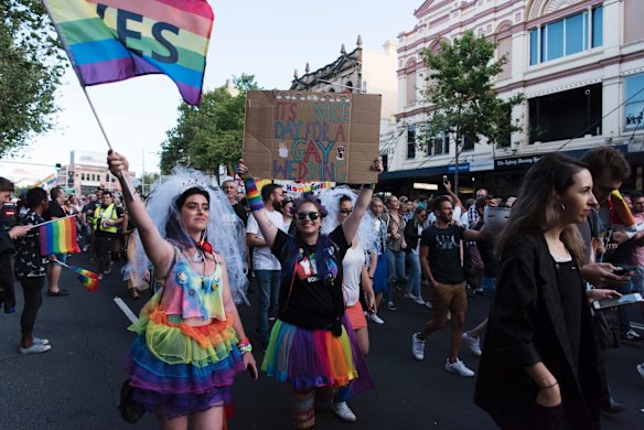 Crowds march down Oxford St, Darlinghurst this evening to celebrate the majority yes vote of the results of the postal vote.