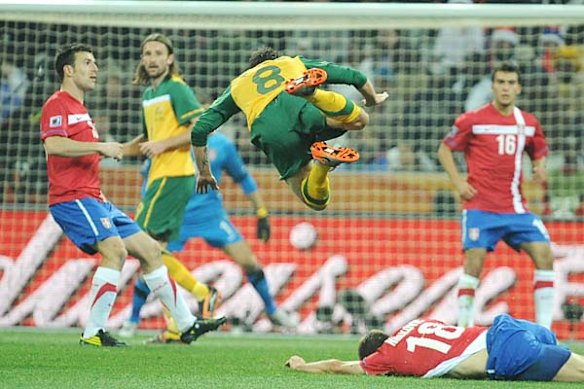 Luke Wilkshire goes flying.