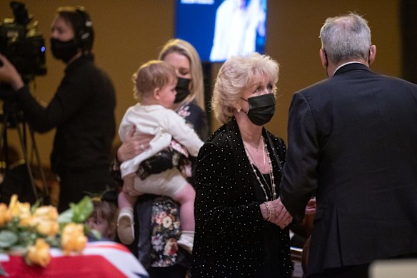 Patti Newton and daughter Lauren, with baby, at the state funeral service. 