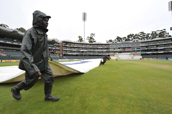 Ground staff pull on the covers in the morning. Rain prevented any play before lunch.