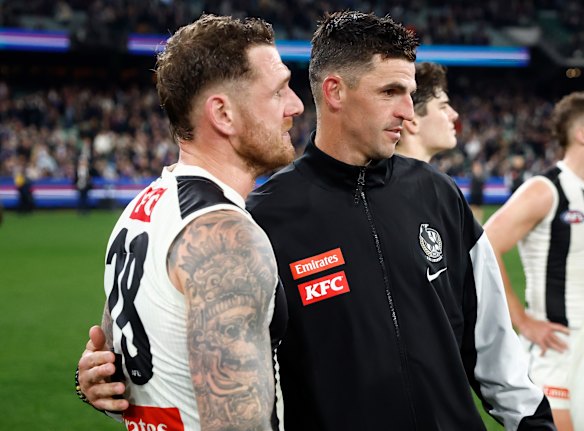 All over: Tim Membrey is consoled by teammate Scott Pendlebury on Friday night.