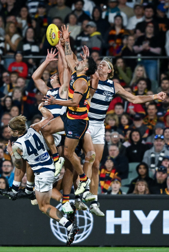 Izak Rankine of the Crows high in the pack over Tom Stewart of the Cats