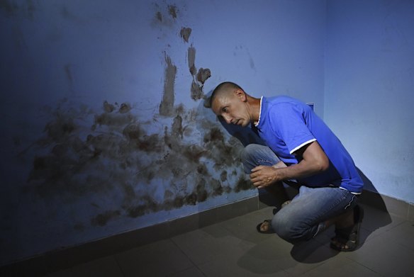 Civilian computer technician Olekdsndr Fayizov, 41, show bloodstains where Russian soldiers beat his head against the wall of a room used as a cell in the basement of the Trostyanets railway station. The Russians used the railway station as a base during their occupation of the town.