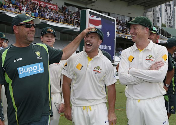 Australia's Coach Darren Lehmann, left, Dave Warner, center, and Brad Haddin, right,  celebrate after winning their Ashes cricket test match over England.